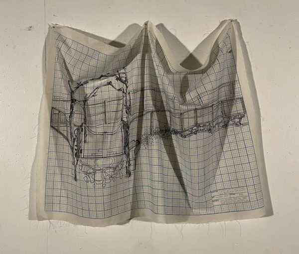 Blueprint ink drawing of an arbor on gridded fabric draped on wall.