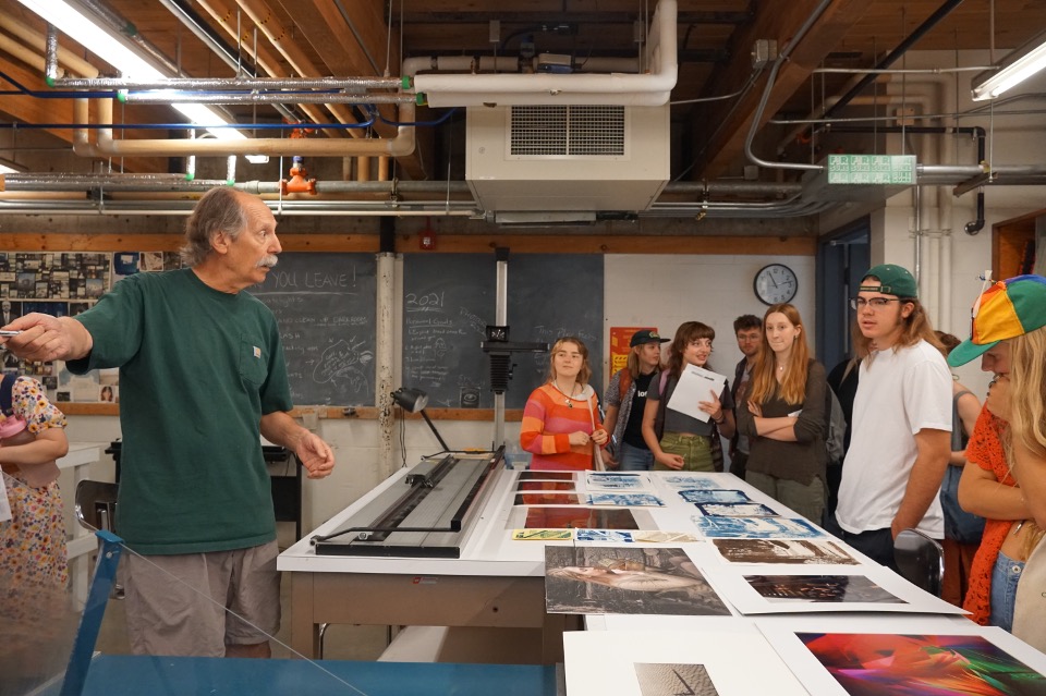 Teacher demonstrates photography technique.