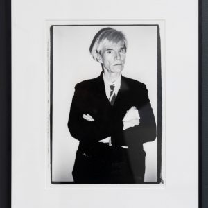 a framed black and white portrait of the pop artist Andy Warhol