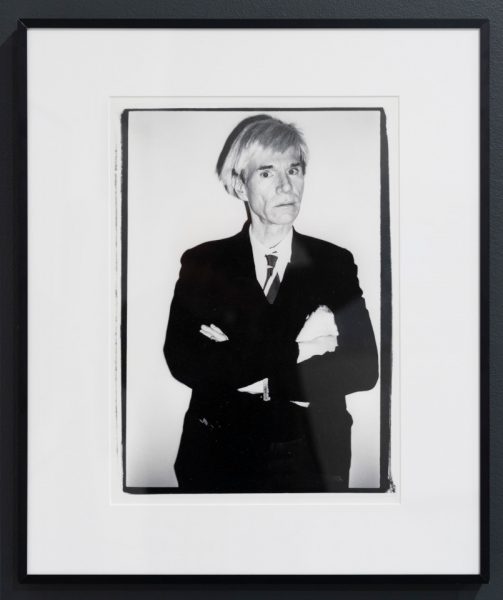 a framed black and white portrait of the pop artist Andy Warhol