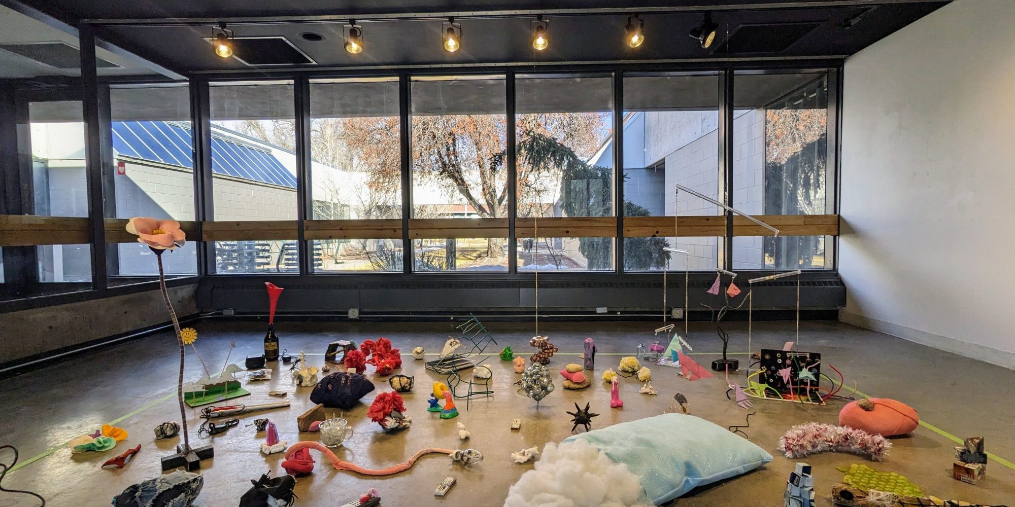 picture of small sculptures made of found material on gallery floor