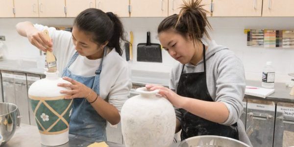 Colorado State University art students Rothavie Toum and Erica Howe apply glaze to their projects in Sanam Emami's pottery class, November 15, 2018.